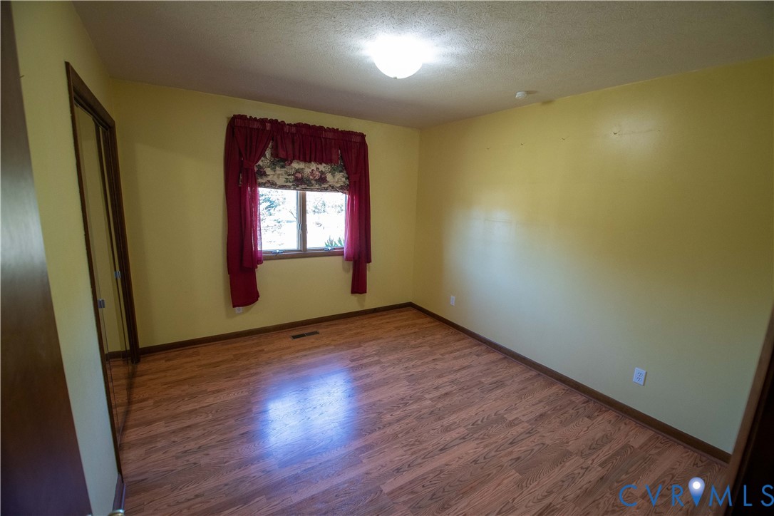 3574 Blose Road Elkton, VA 22827 - Photo 13 of 49 Empty room featuring wood finished floors and a te
