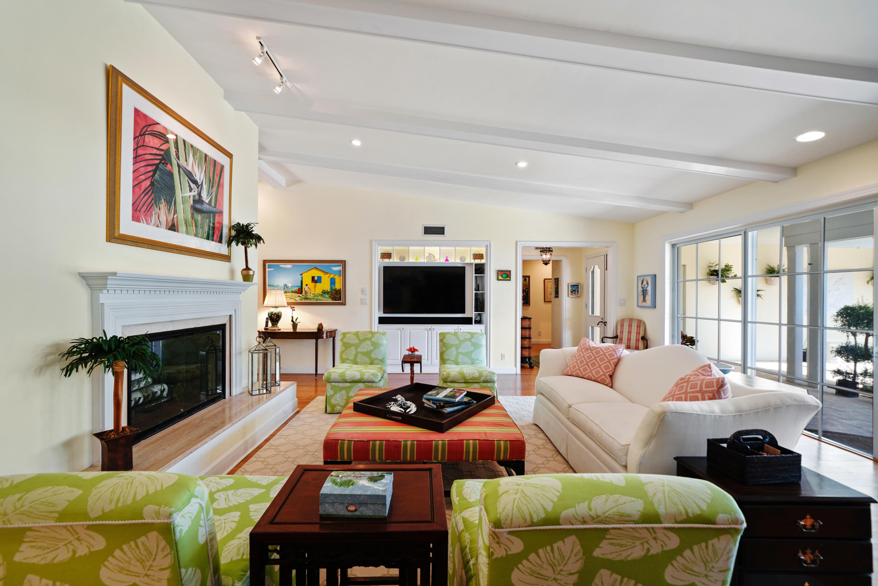 a living room with furniture a flat screen tv and a fireplace