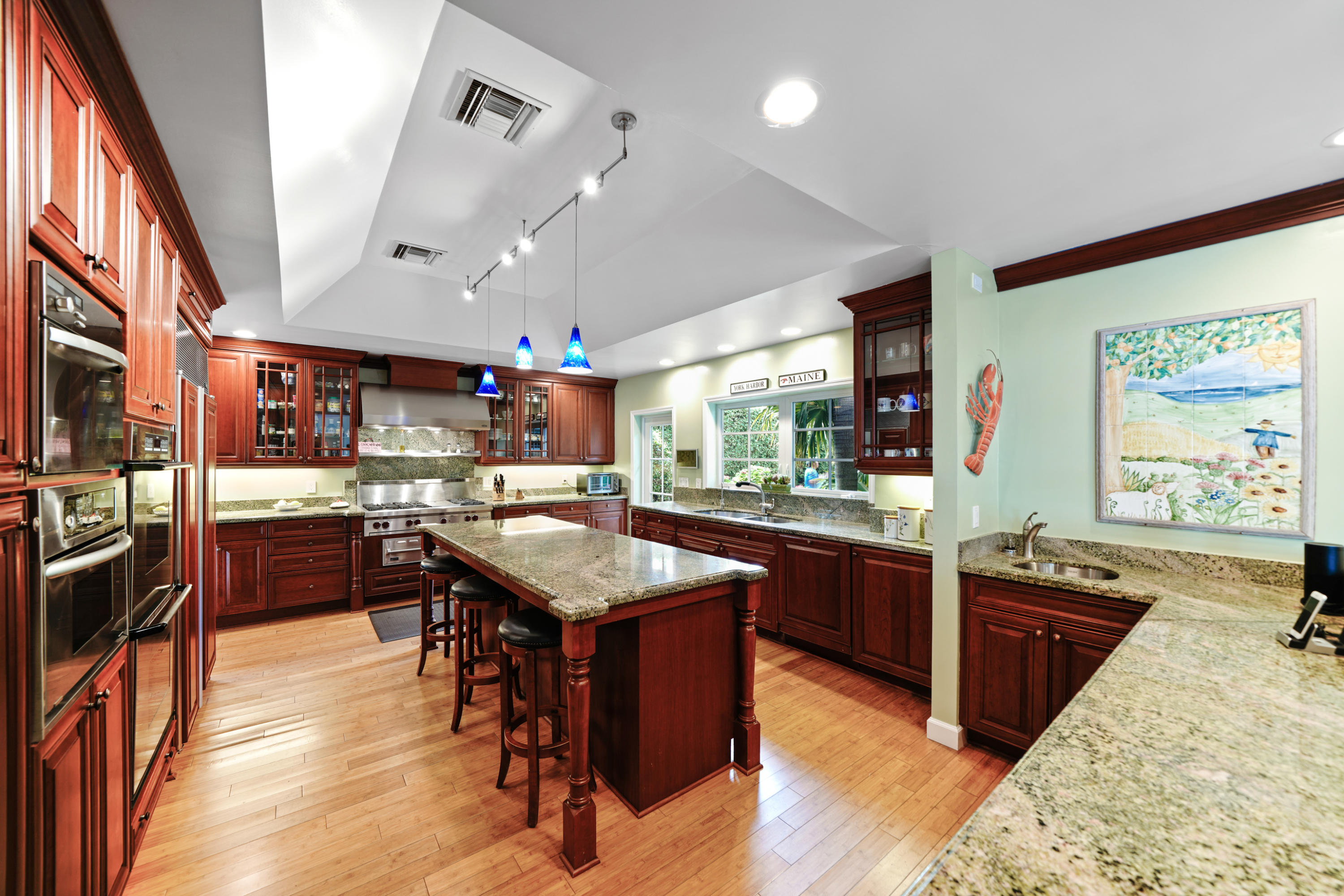 3232 Gulf Stream Road Gulf Stream, FL 33483 - Photo 25 of 36 a kitchen with stainless steel appliances granite countertop sink stove top oven and cabinets