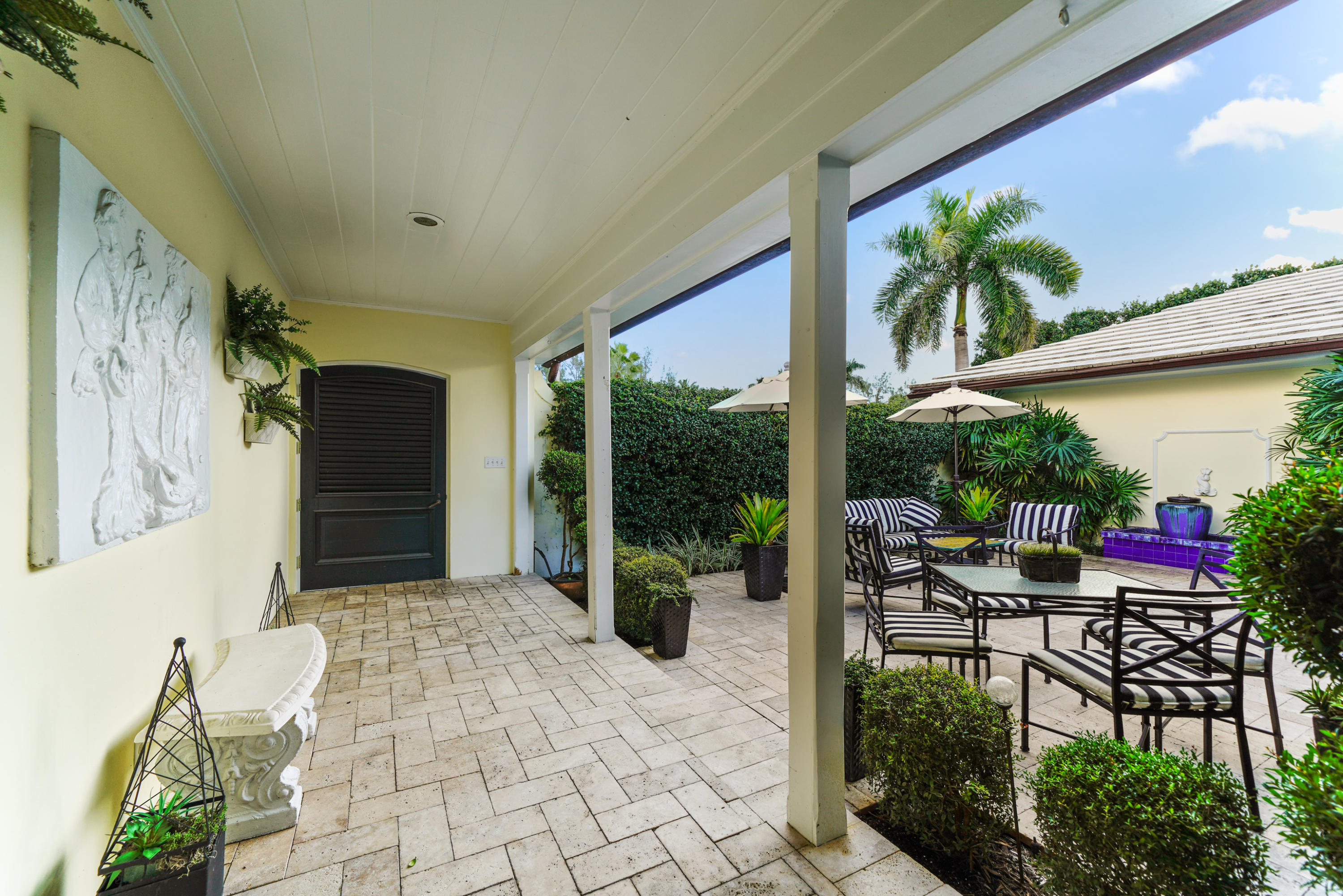 3232 Gulf Stream Road Gulf Stream, FL 33483 - Photo 3 of 36 a view of a porch with chairs and potted plants