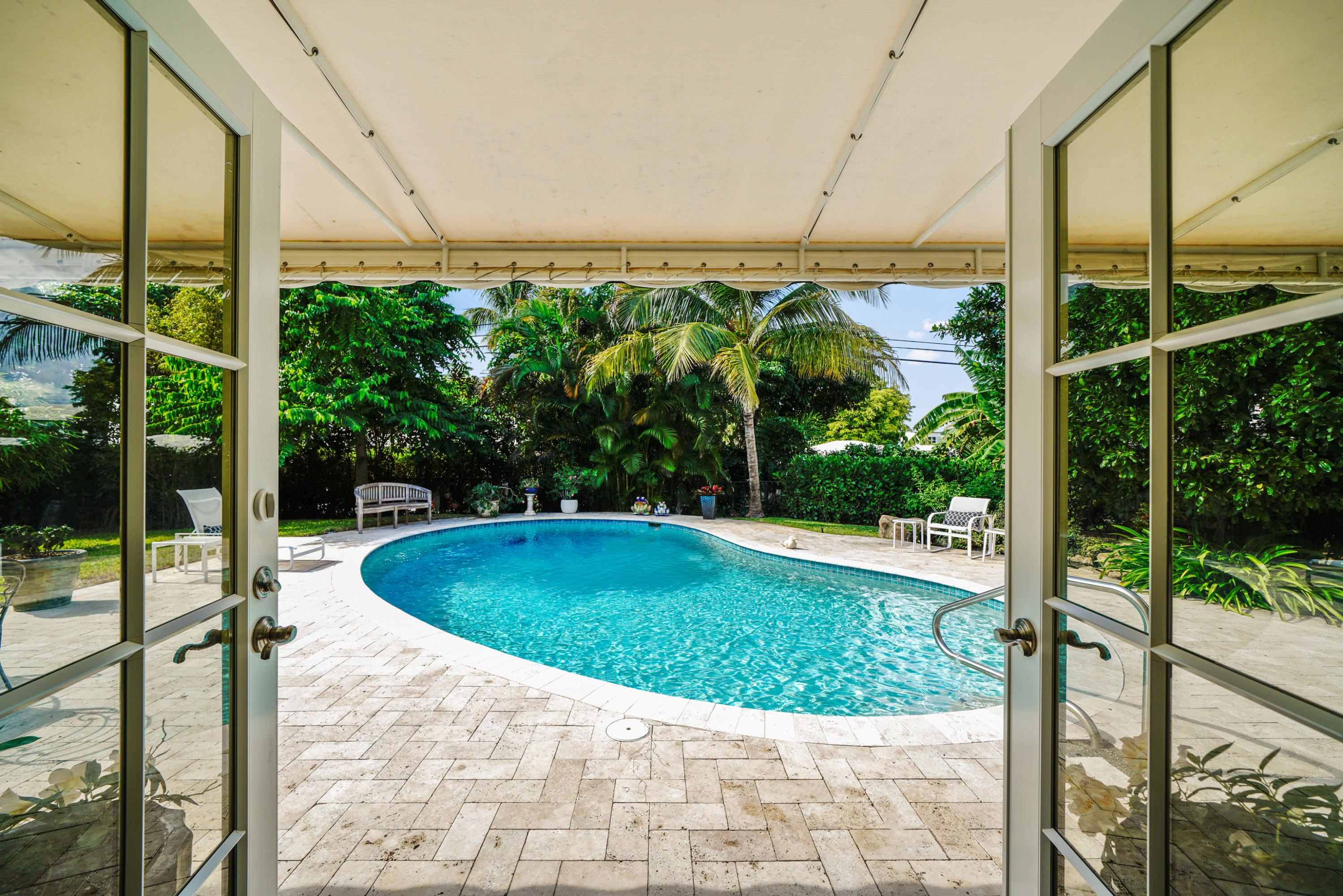 3232 Gulf Stream Road Gulf Stream, FL 33483 - Photo 32 of 36 a view of a swimming pool with a yard
