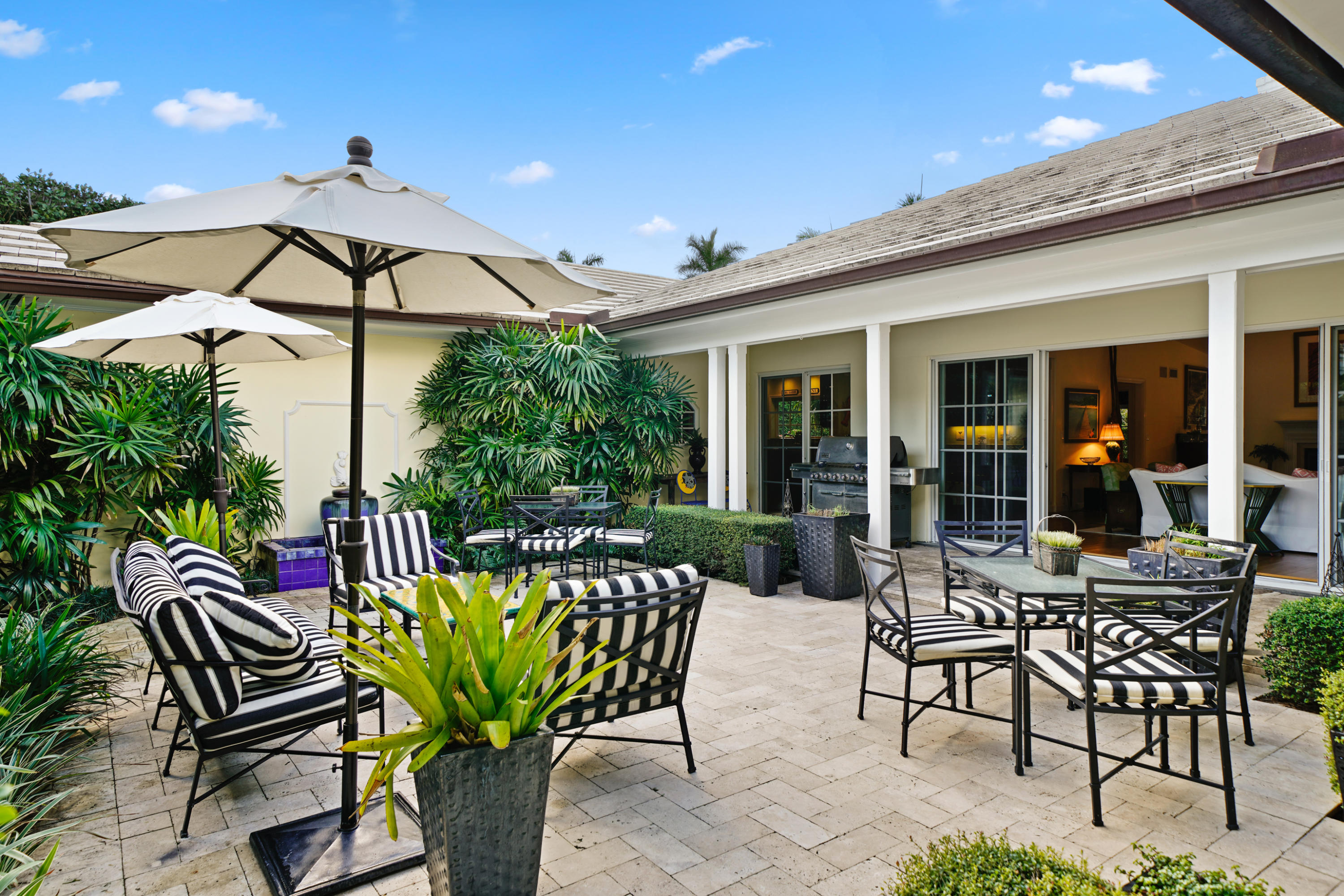 3232 Gulf Stream Road Gulf Stream, FL 33483 - Photo 4 of 36 a view of a dinning table and chairs in patio