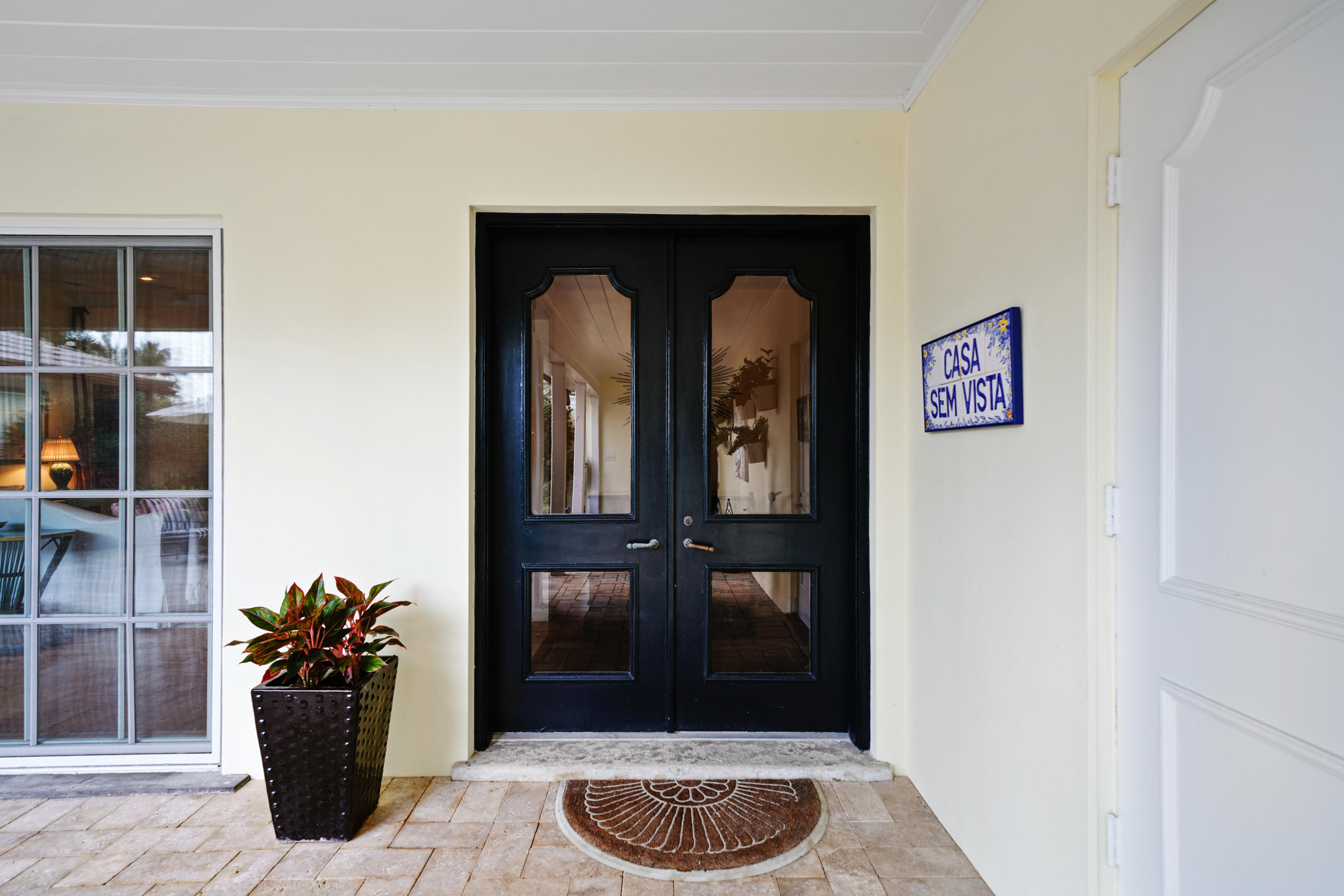3232 Gulf Stream Road Gulf Stream, FL 33483 - Photo 6 of 36 a view of a hallway with wooden floor and a potted plant