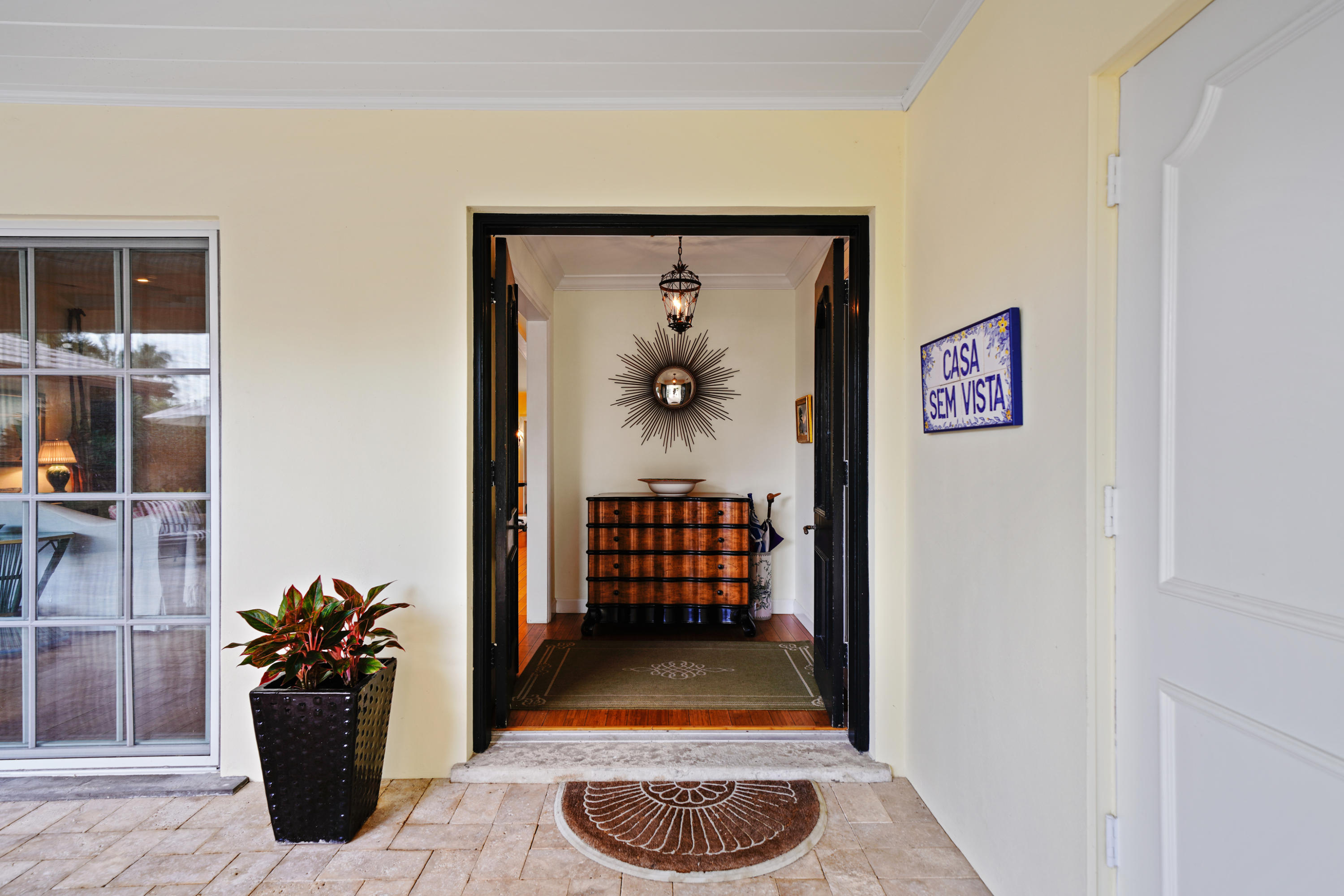 3232 Gulf Stream Road Gulf Stream, FL 33483 - Photo 7 of 36 a view of a hallway with wooden floor and a potted plant