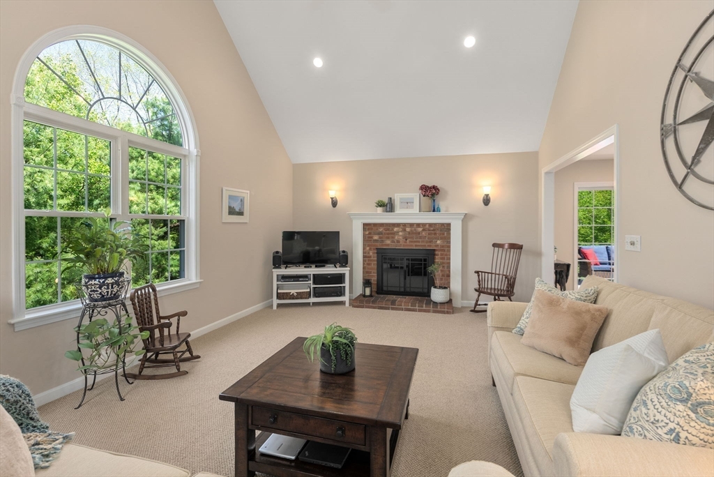 7 Brook Hill Road Sturbridge, MA 01518 - Photo 14 of 41 a living room with furniture a fireplace and a large window