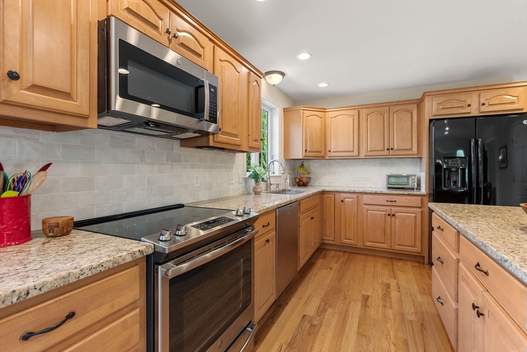 7 Brook Hill Road Sturbridge, MA 01518 - Photo 18 of 41 a kitchen with a sink stove and microwave