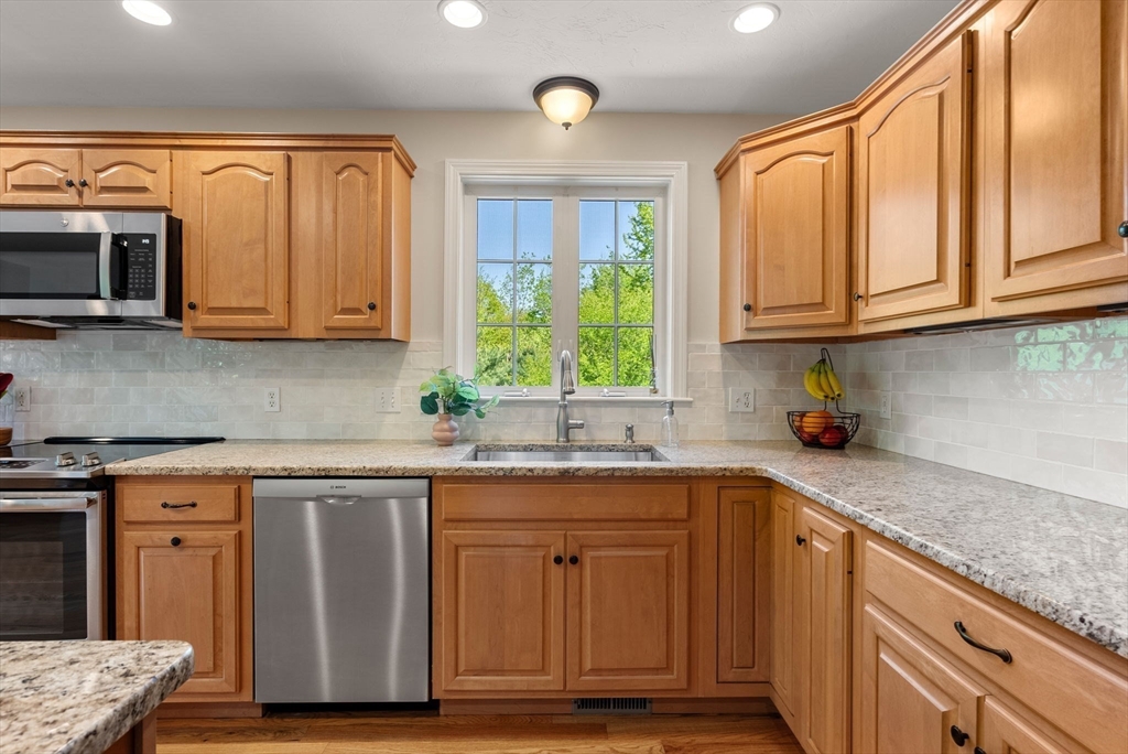 7 Brook Hill Road Sturbridge, MA 01518 - Photo 19 of 41 a kitchen with stainless steel appliances granite countertop a sink a stove and cabinets