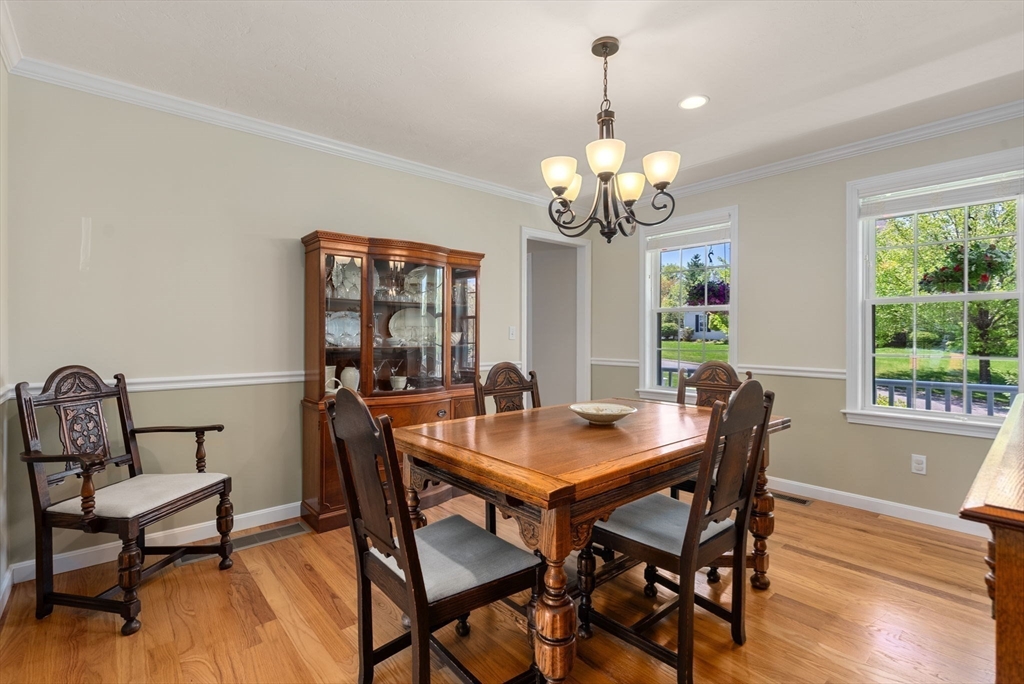 7 Brook Hill Road Sturbridge, MA 01518 - Photo 23 of 41 a view of a dining room with furniture a chandelier and wooden floor