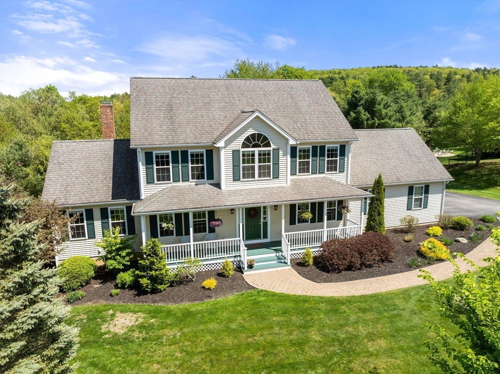 7 Brook Hill Road Sturbridge, MA 01518 - Photo 6 of 41 a front view of a house with a yard table and chairs