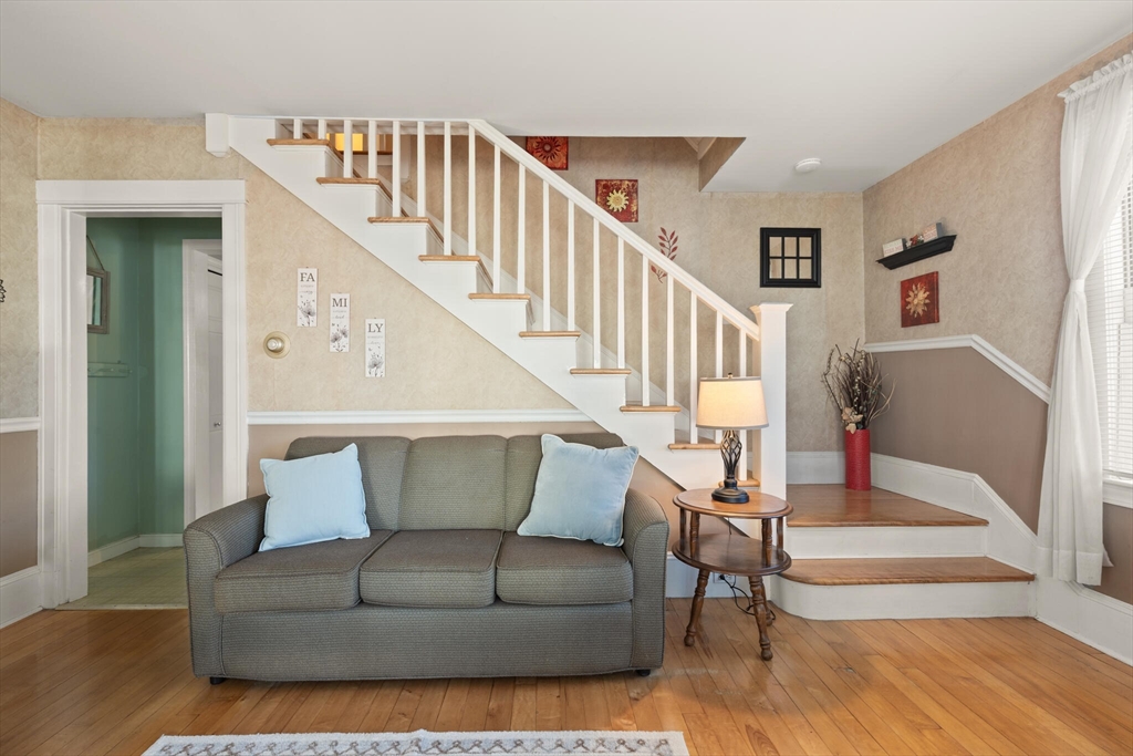 35 Roosevelt Street, Unit 35 Maynard, MA 01754 - Photo 15 of 39 a living room with wooden floor and stairs