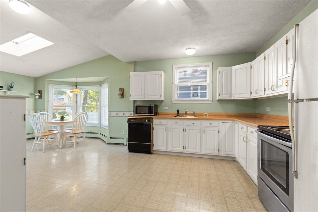 35 Roosevelt Street, Unit 35 Maynard, MA 01754 - Photo 16 of 39 a large kitchen with granite countertop a large counter top space a sink stainless steel appliances and cabinets