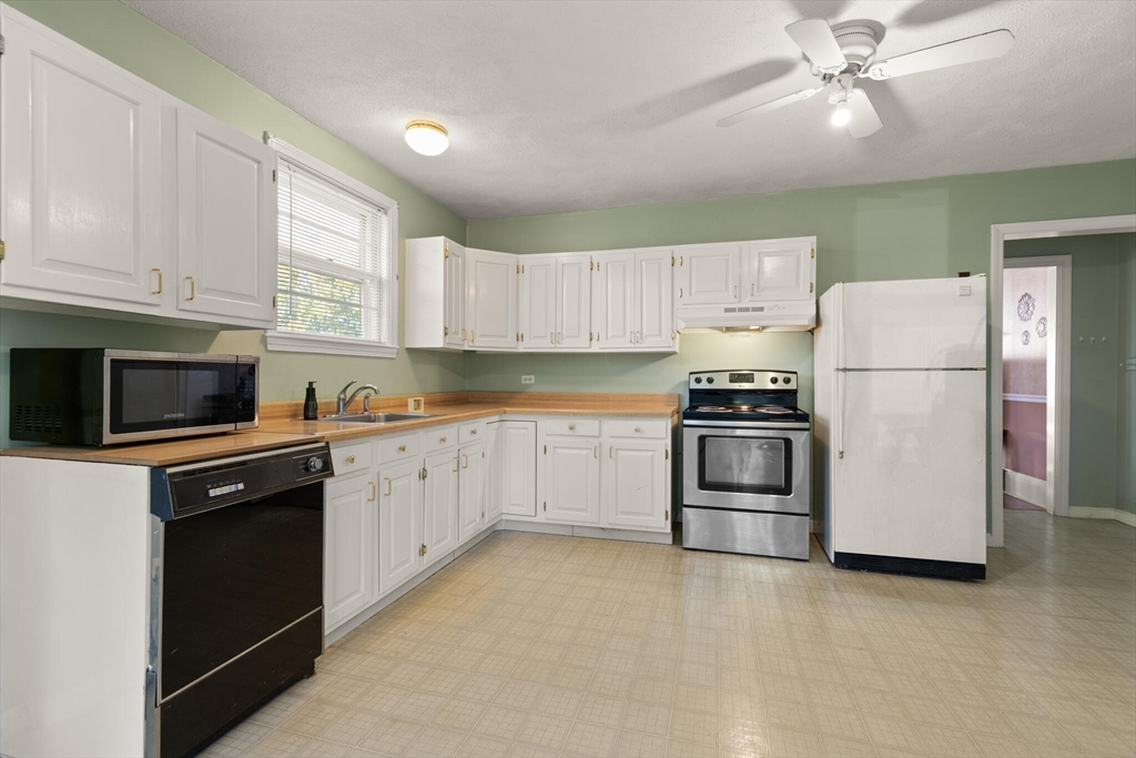 35 Roosevelt Street, Unit 35 Maynard, MA 01754 - Photo 18 of 39 a kitchen with cabinets stainless steel appliances and a window
