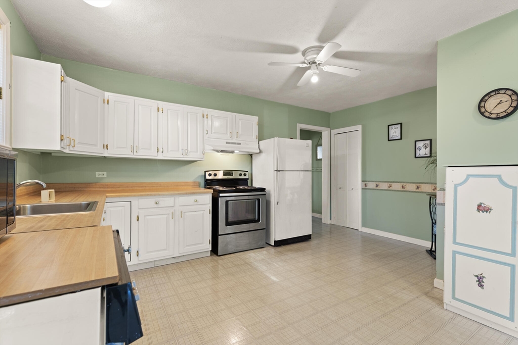 35 Roosevelt Street, Unit 35 Maynard, MA 01754 - Photo 19 of 39 a kitchen with a refrigerator a stove top oven a sink and dishwasher