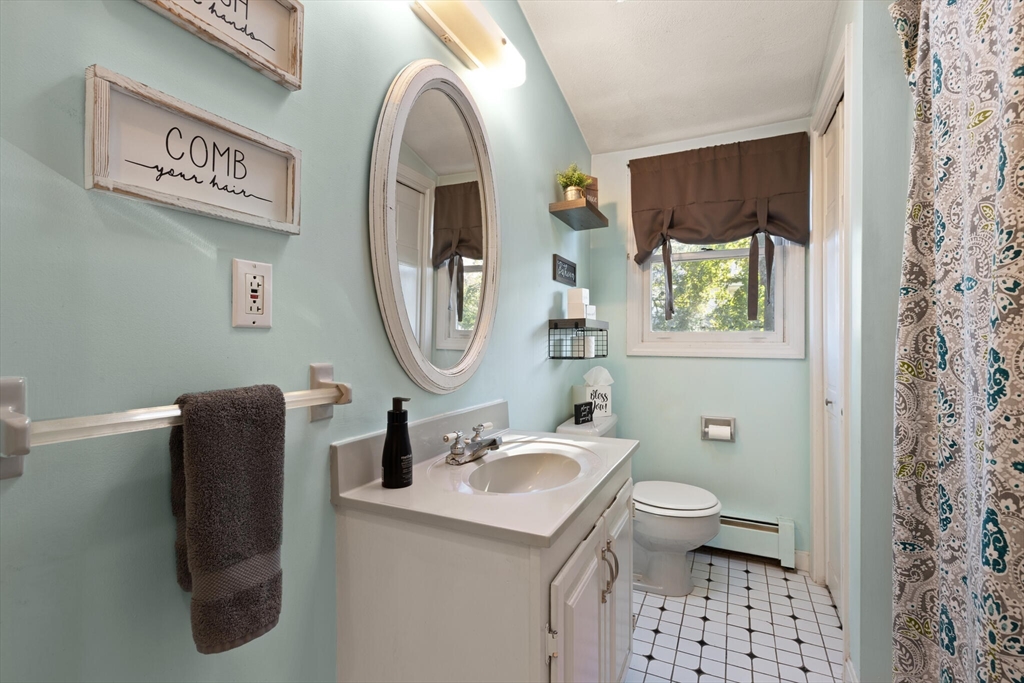 35 Roosevelt Street, Unit 35 Maynard, MA 01754 - Photo 25 of 39 a bathroom with a sink toilet and a mirror