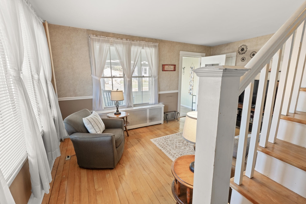 35 Roosevelt Street, Unit 35 Maynard, MA 01754 - Photo 27 of 39 a living room with furniture and a refrigerator