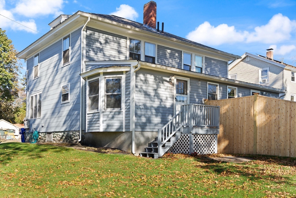 35 Roosevelt Street, Unit 35 Maynard, MA 01754 - Photo 4 of 39 a view of a house with a fence in a backyard