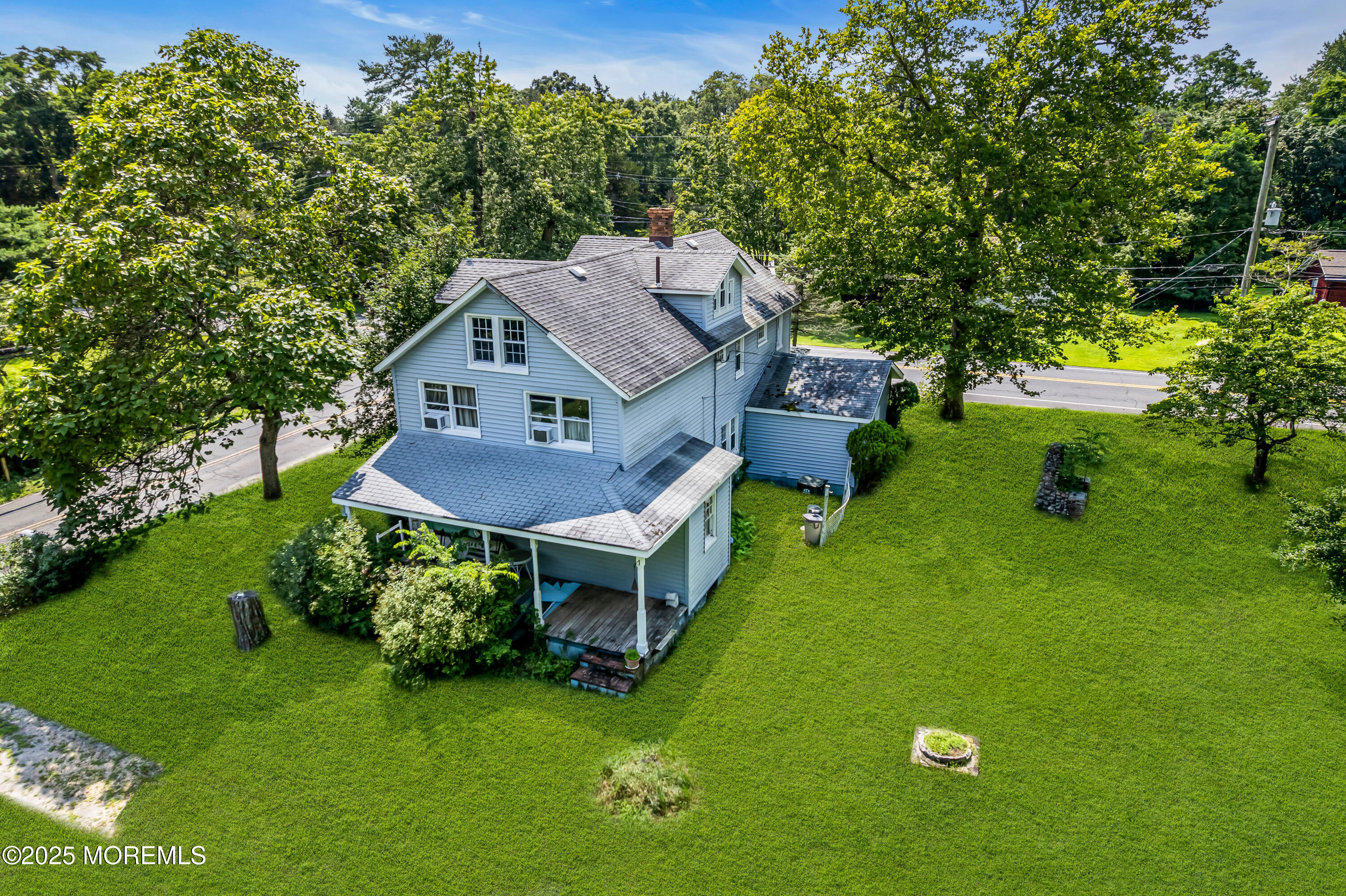 200 Cranberry Road Farmingdale, NJ 07727 - Photo 1 of 72 a aerial view of a house with a yard table and chairs