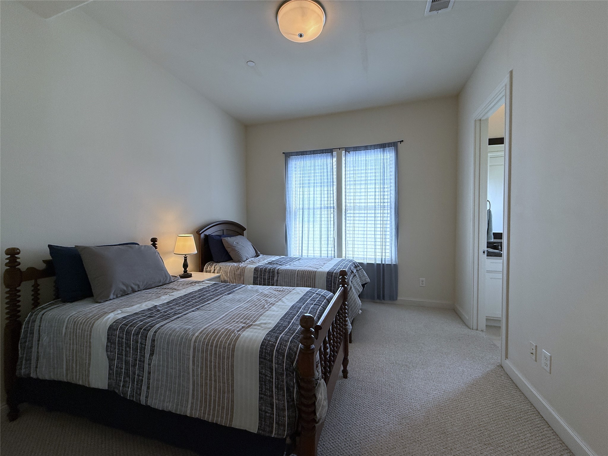 705 Delano Street Houston, TX 77003 - Photo 16 of 28 a bedroom with a bed and window