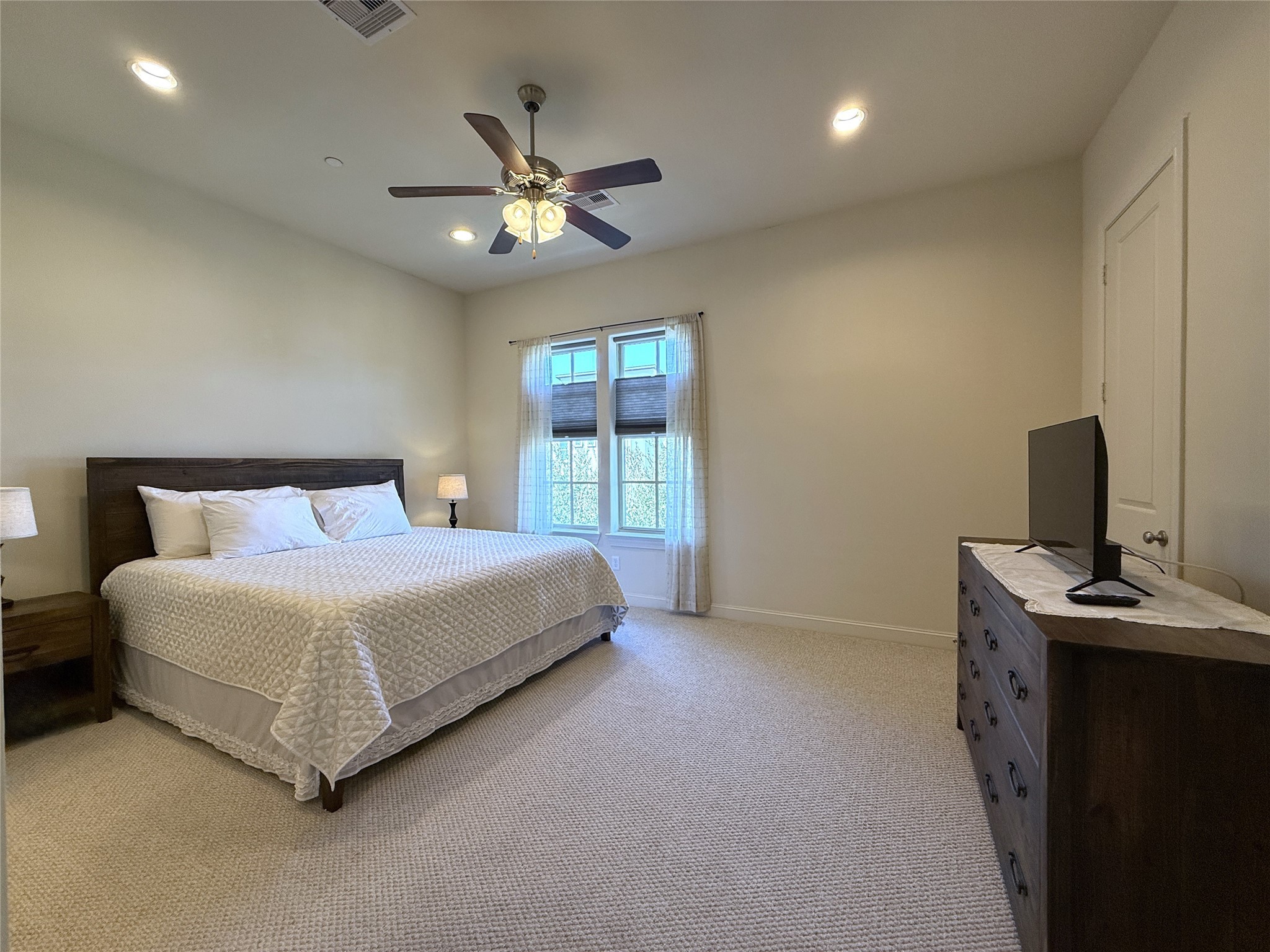 705 Delano Street Houston, TX 77003 - Photo 18 of 28 a bedroom with a bed and a chandelier
