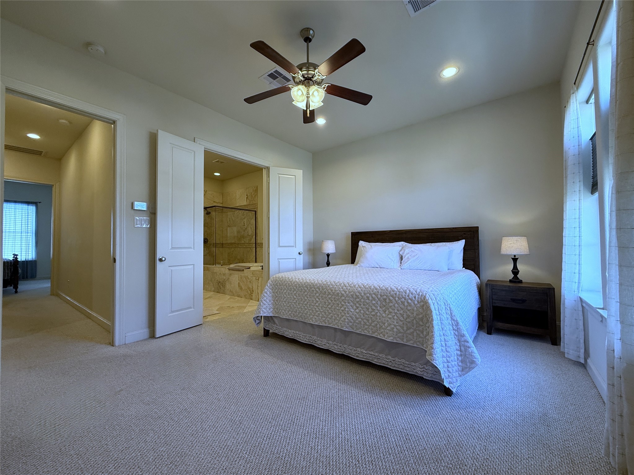 705 Delano Street Houston, TX 77003 - Photo 19 of 28 a spacious bedroom with a bed and a chandelier