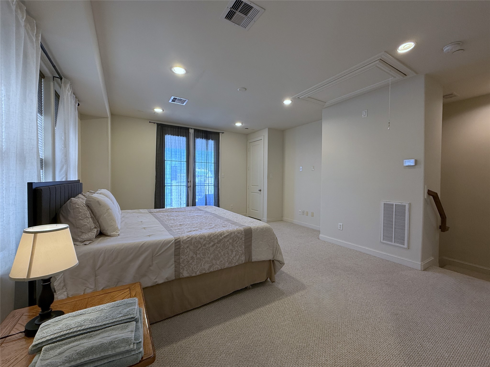 705 Delano Street Houston, TX 77003 - Photo 22 of 28 a spacious bedroom with a bed and a couch