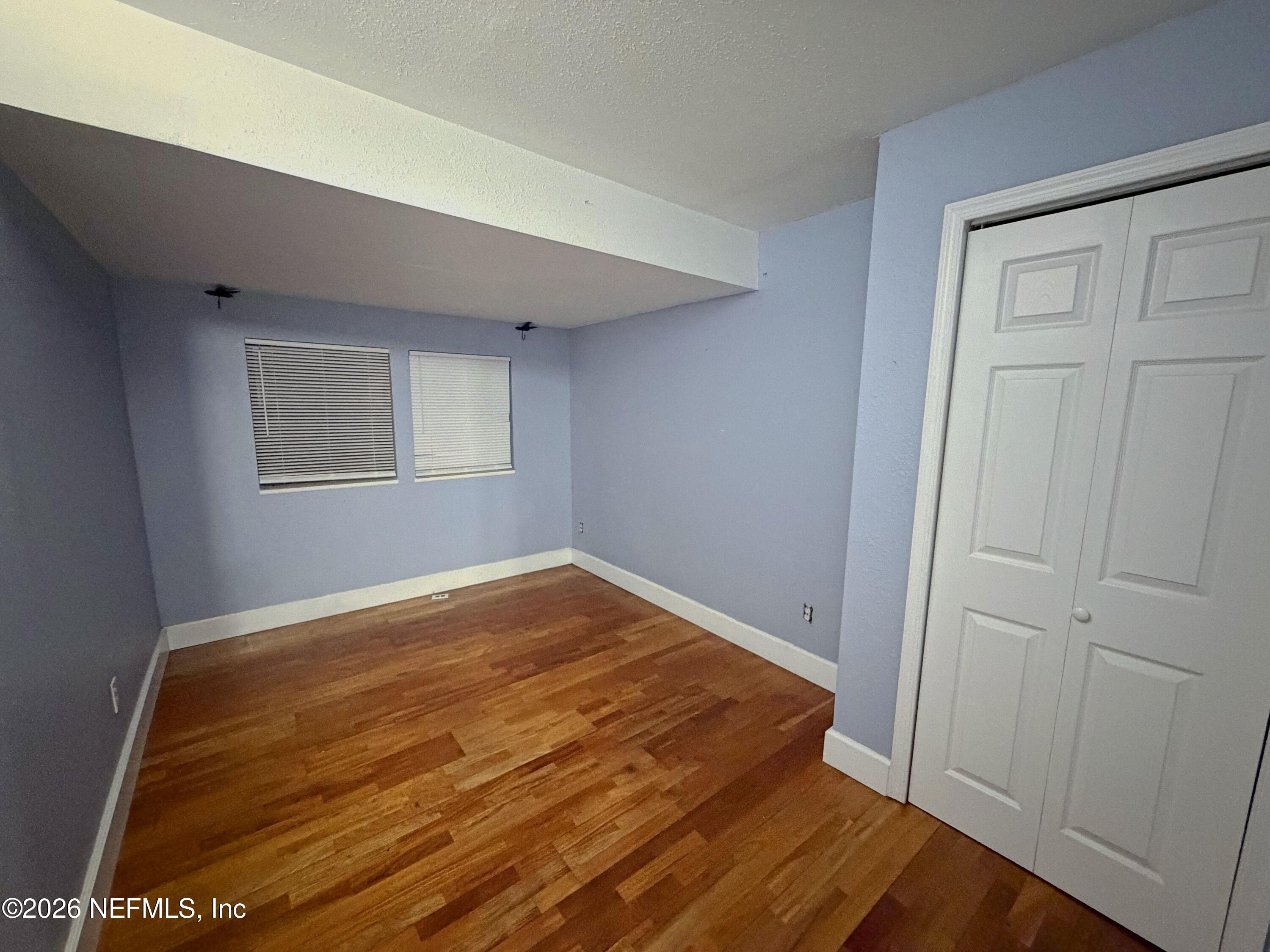 8 10th Street, Unit B St. Augustine, FL 32080 - Photo 7 of 14 a view of empty room with wooden floor