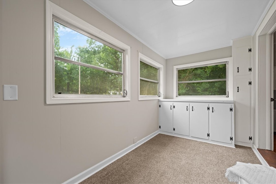 174 Holliday Road Six Mile, SC 29682 - Photo 21 of 49 Sun-filled room featuring multiple windows with built-in storage cabinets