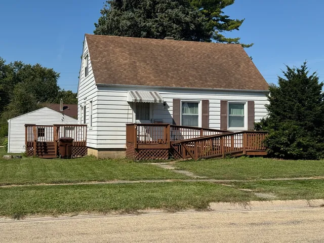 a view of a house with a yard patio and a garden
