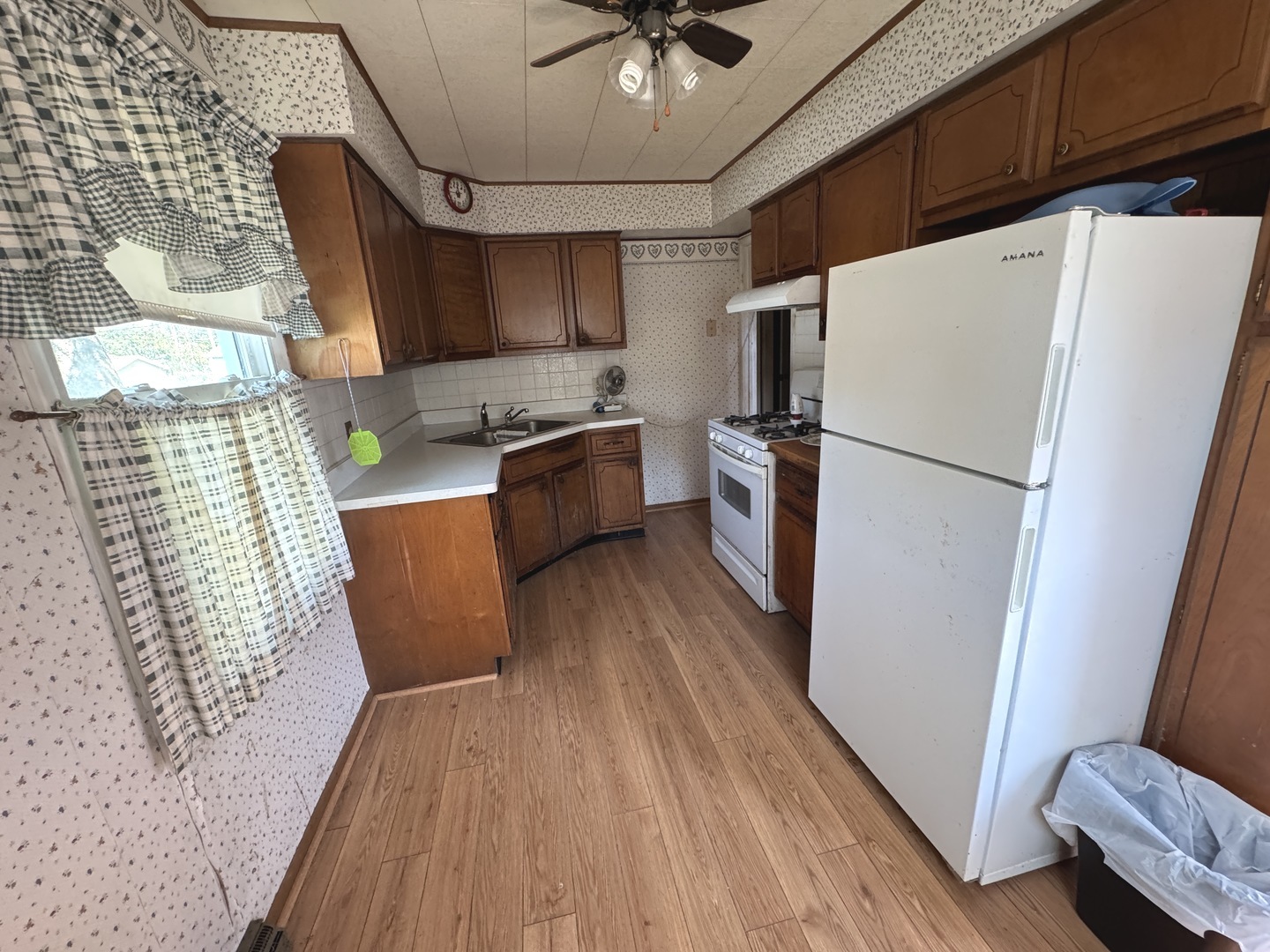 836 North 11th Street Rochelle, IL 61068 - Photo 4 of 11 a kitchen with stainless steel appliances a refrigerator a sink a stove a microwave oven with wooden floor