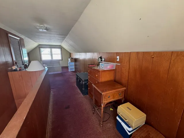 a living room with furniture and a chair