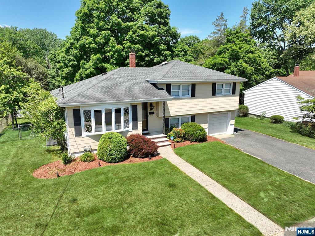 30 Brookfield Road Dumont, NJ 07628 - Photo 49 of 50 a front view of a house with a yard