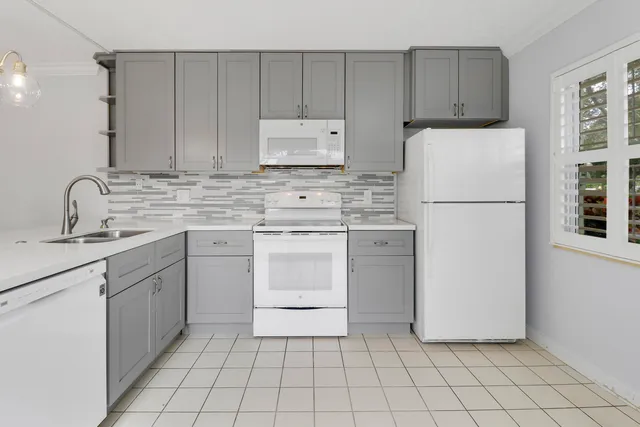 a kitchen with a sink appliances and cabinets