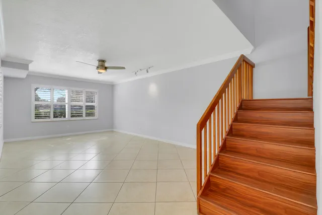 a view of an empty room with stairs and ventilation