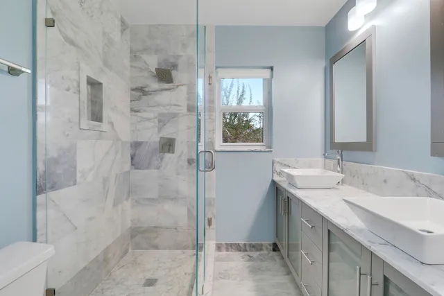a bathroom with a shower sink and mirror