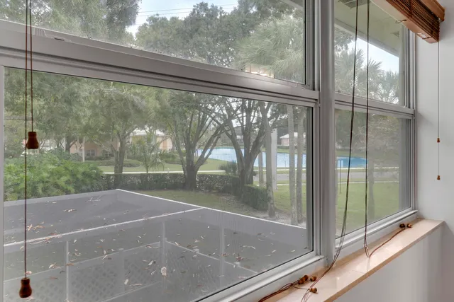 a view of a glass door with a yard from a window