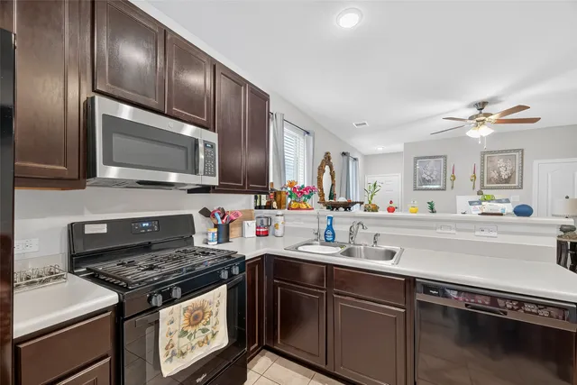 a kitchen with stainless steel appliances a sink stove and microwave