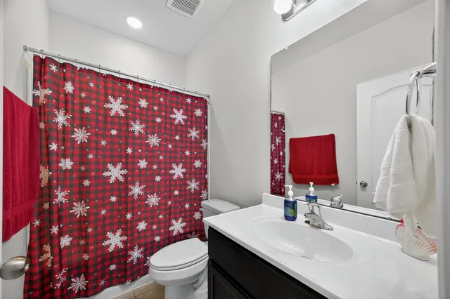 a bathroom with a sink toilet and mirror