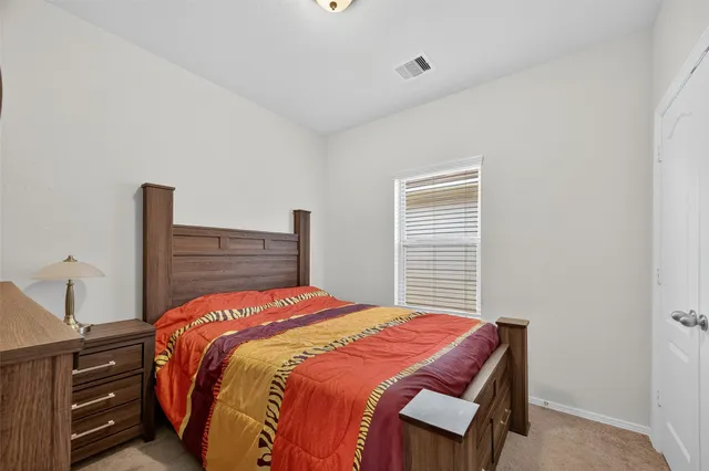 a bedroom with a bed and dresser
