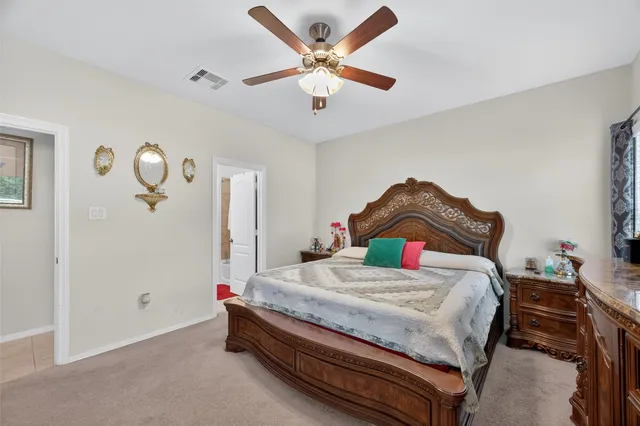 a bedroom with a bed and dresser