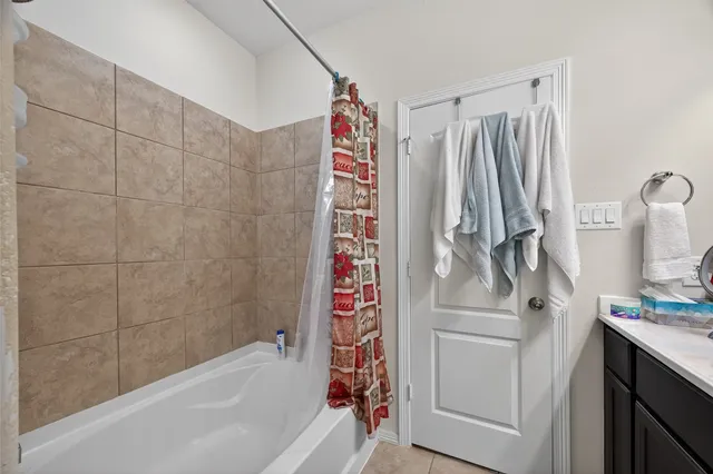 a bathroom with a shower curtain and a sink