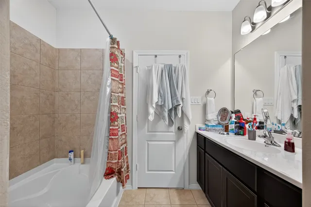 a bathroom with a double vanity sink mirror and shower