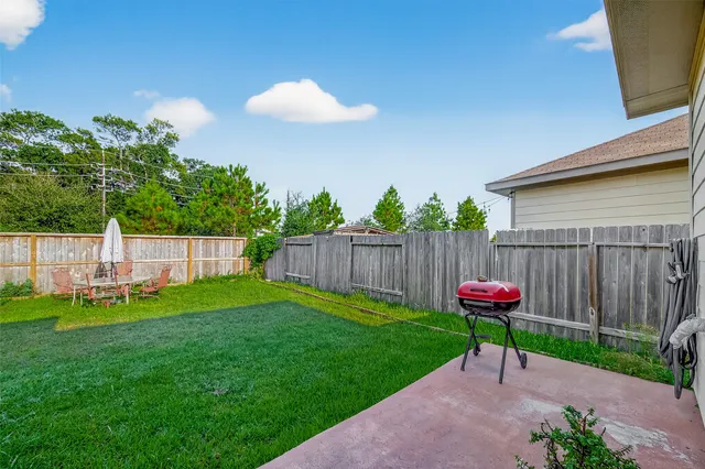 a view of a backyard with a table and chairs