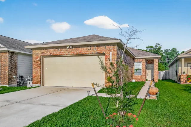a front view of house with a garden