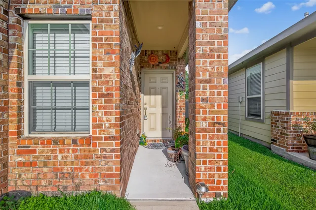 a view of a brick house with many windows