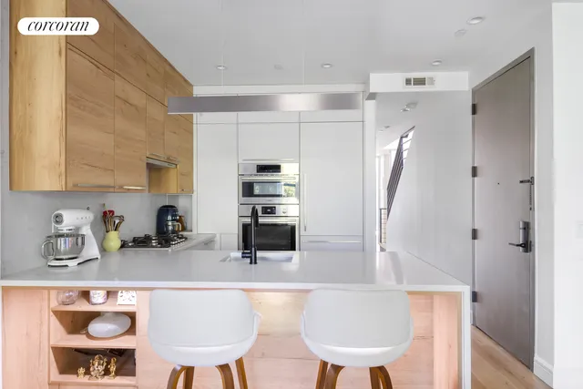 a kitchen with stainless steel appliances granite countertop a refrigerator and a sink