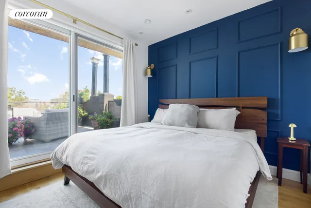 a large bed sitting in a bedroom next to a window