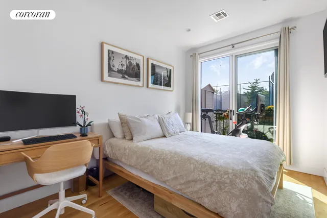 a bedroom with a bed and glass door