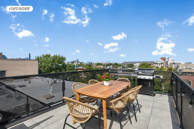 a balcony with table and chairs
