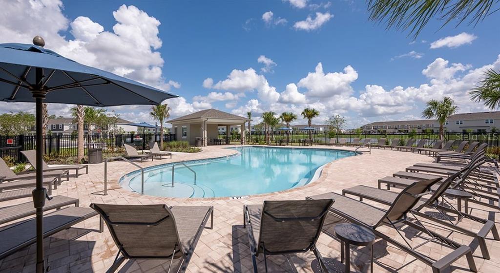 13134 Stable Place Parrish, FL 34219 - Photo 26 of 28 a view of a swimming pool with lounge chairs