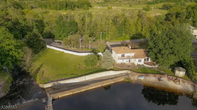 an aerial view of residential houses with outdoor space and swimming pool